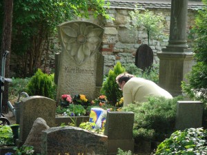 A person paying respect at the grave