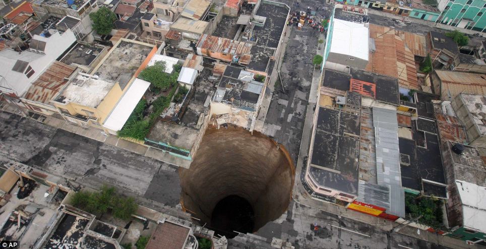 Sink hole: This incredible picture shows a 200ft-deep hole in an intersection in downtown Guatemala City. In the top left of the intersection stood a three-storey building