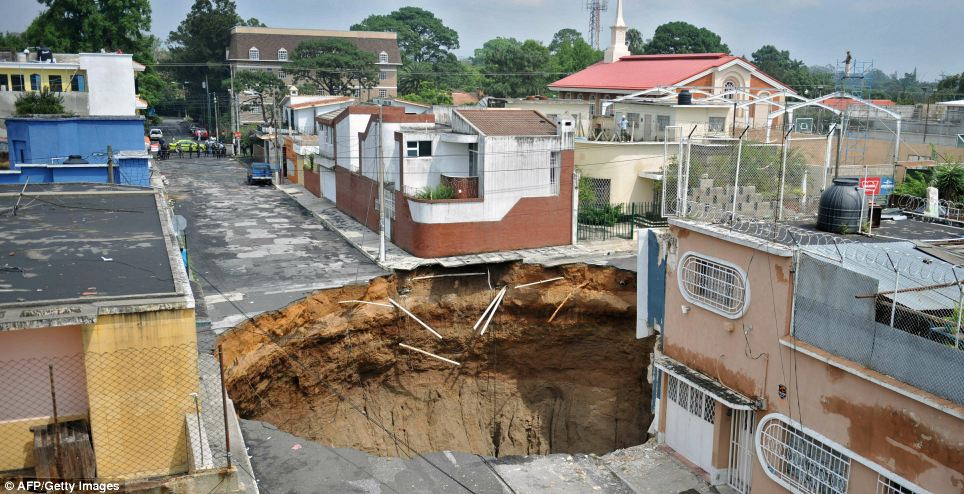 Lucky escape: Neighbouring buildings are left untouched after torrential rain led to this huge crater forming in the capital. The area has been closed off and evacuated  Read more: http://www.dailymail.co.uk/news/worldnews/article-1283066/Guatemala-sink-hole-Tropical-storm-Agatha-blows-200ft-hole-city.html#ixzz0pbH6yO4l