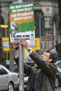 Ireland Britain Royal Visit A protester puts up a placard to protest at the visit by Britain's Queen Elizabeth II to Ireland, Monday, May, 16, 2011. Queen Elizabeth II begins a four day visit to Ireland on Tuesday for the first time since Irish Independence. (AP Photo/Peter Morrison)
