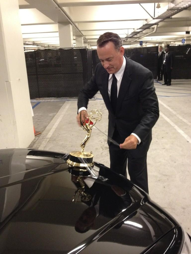 Tom Hanks attempts to turn his limo car into a Rolls Royce... by taping his Emmy to car bonnet