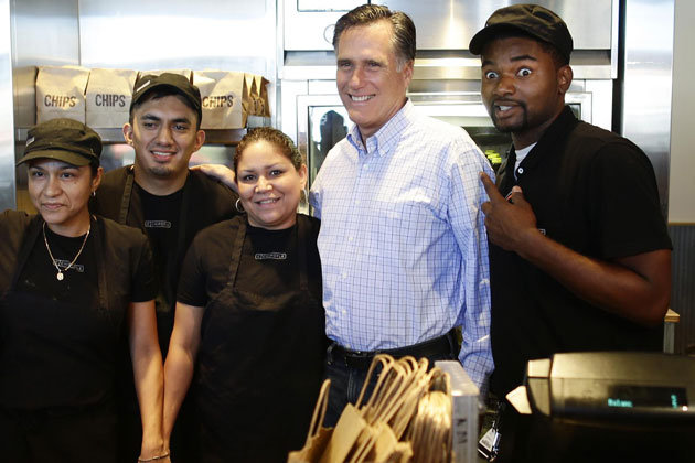 Mitt Romney poses with excited Chipotle employees in Denver. (Charles Dharapak/AP)