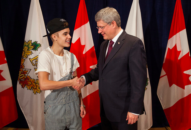 Prime Minister of Canada Stephen Harper presents Justin Bieber with Diamond Jubliee Medal.