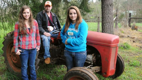 Two girls lift tractor off dad: Teens lift 3,000 pound tractor, save father